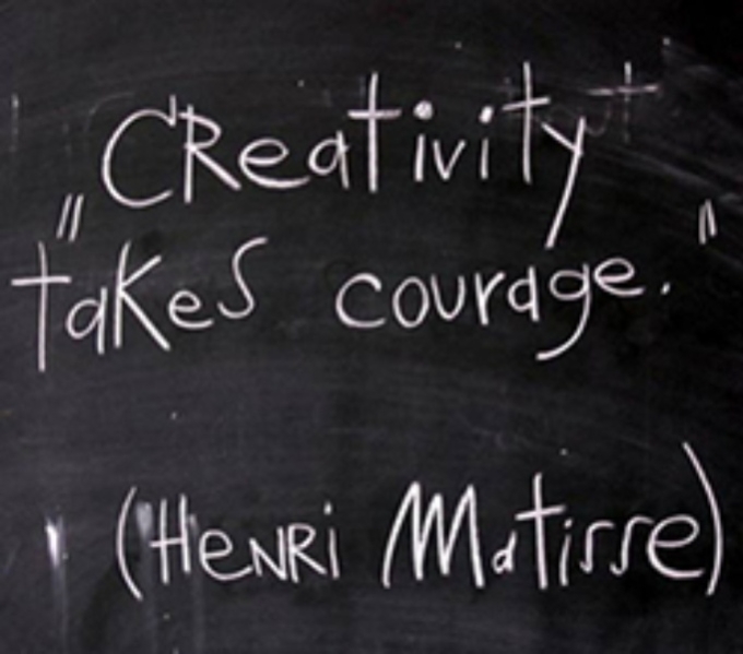 Written in white chalk is Creativity Takes Courage; a quote by Henri Matisse