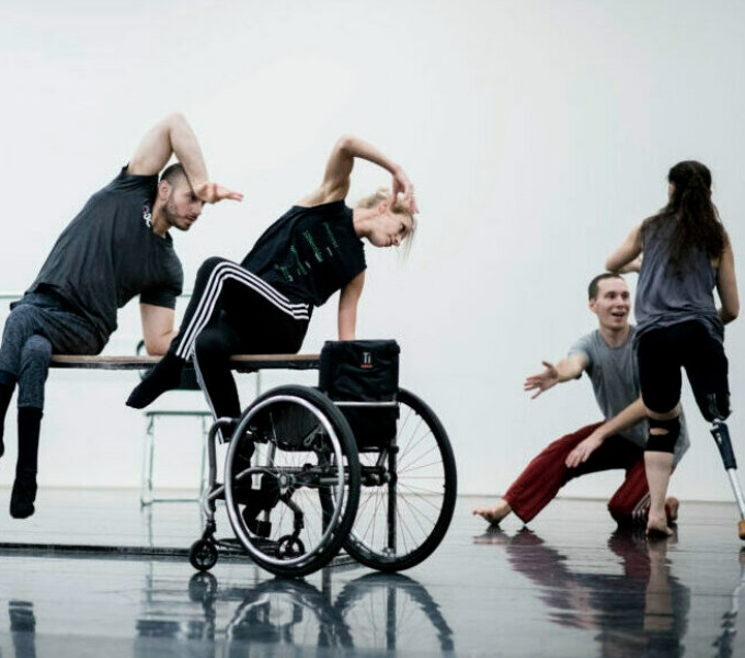 Dancers in a white studio space.