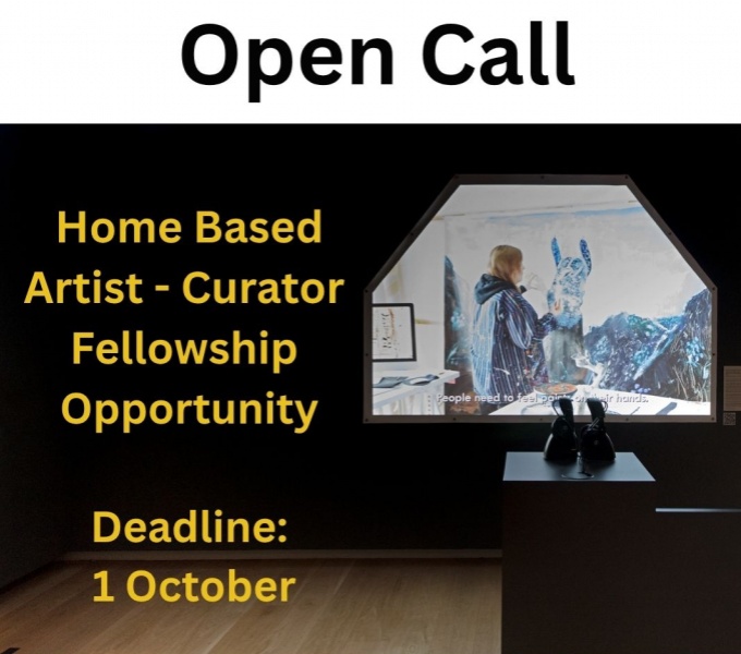 Image Description: A white background with the the words Open Call in large black font.  Below is an image of a dark gallery space with a film projection onto the wall. In the foreground is a plinth with black boots in silhouette. 
