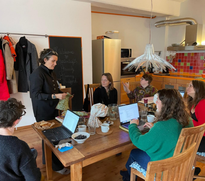 The DASH team meet members of Berlinklusion around a table.