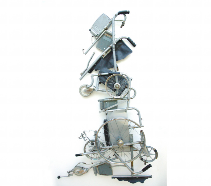 A photograph of a collection of wheelchair parts arranged in the shape of the map of Great Britain. 