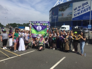 The Shropshire Subversive Stitchers, proudly holding their banner in Cardiff City football stadium before the start of the procession.