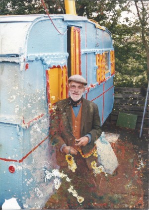 Bill Lock standing next to his colourful caravan