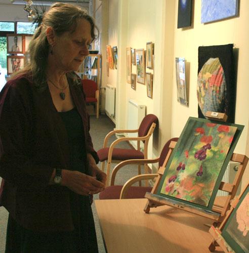 Maralyn Hepworth viewing art work by Charyn Frances