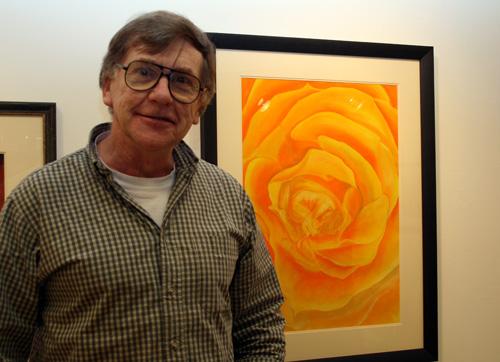 The photgraph shows fine artist, Rob Gemmell, standing next to one of his artowrks, Flowerwoman, at the Qube gallery.  Photograph by Paula Dower copyright DASh